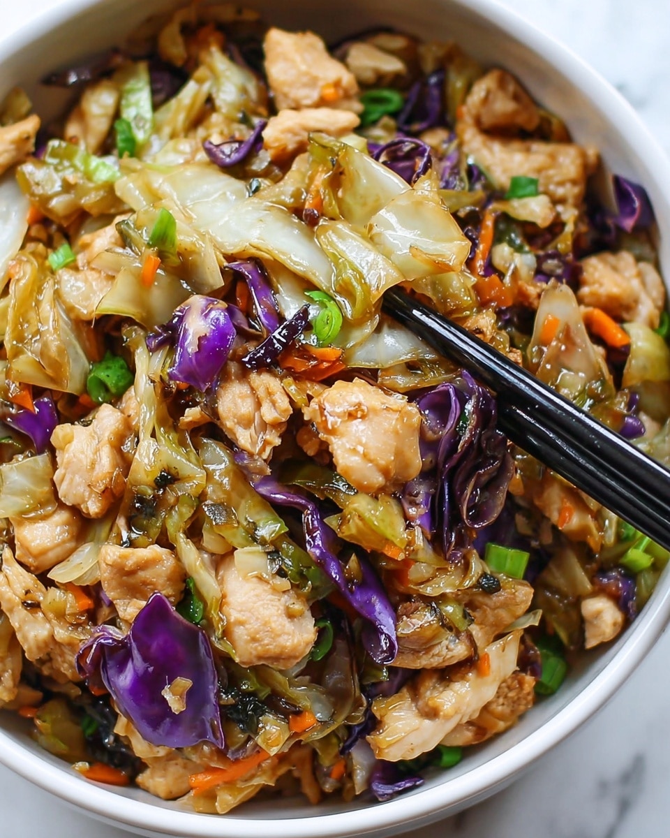 The image shows a white bowl filled with a mixed stir-fry dish consisting of small pieces of light brown cooked chicken, pale green cabbage leaves, and bits of dark purple onion. There are also small pieces of bright green scallions and tiny orange carrot pieces scattered throughout. The food looks moist and cooked with a light brown sauce that slightly shines on the ingredients. A pair of black chopsticks is picking up some of the stir-fry from the right side of the bowl. The bowl sits on a white marbled surface. photo taken with an iphone --ar 4:5 --v 7
