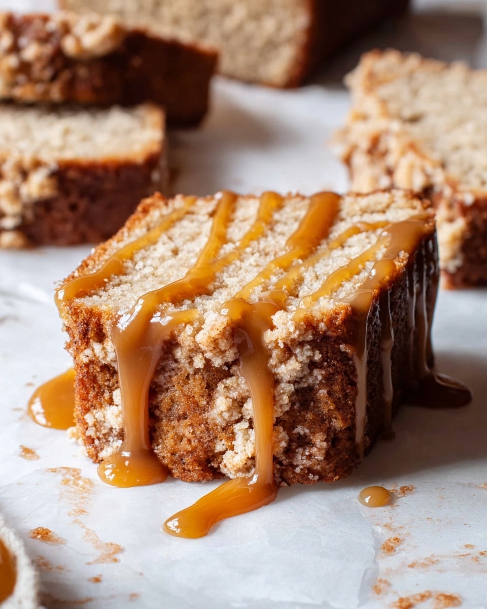 The image shows a single thick slice of crumbly cake with a golden brown crust and a light beige inside. The top of the cake is covered with a glossy caramel sauce that drips down the sides in thick streaks. The cake rests on crinkled white parchment paper against a white marbled background, with other pieces of cake partially visible around it. The texture of the cake appears soft and crumbly. photo taken with an iphone --ar 4:5 --v 7