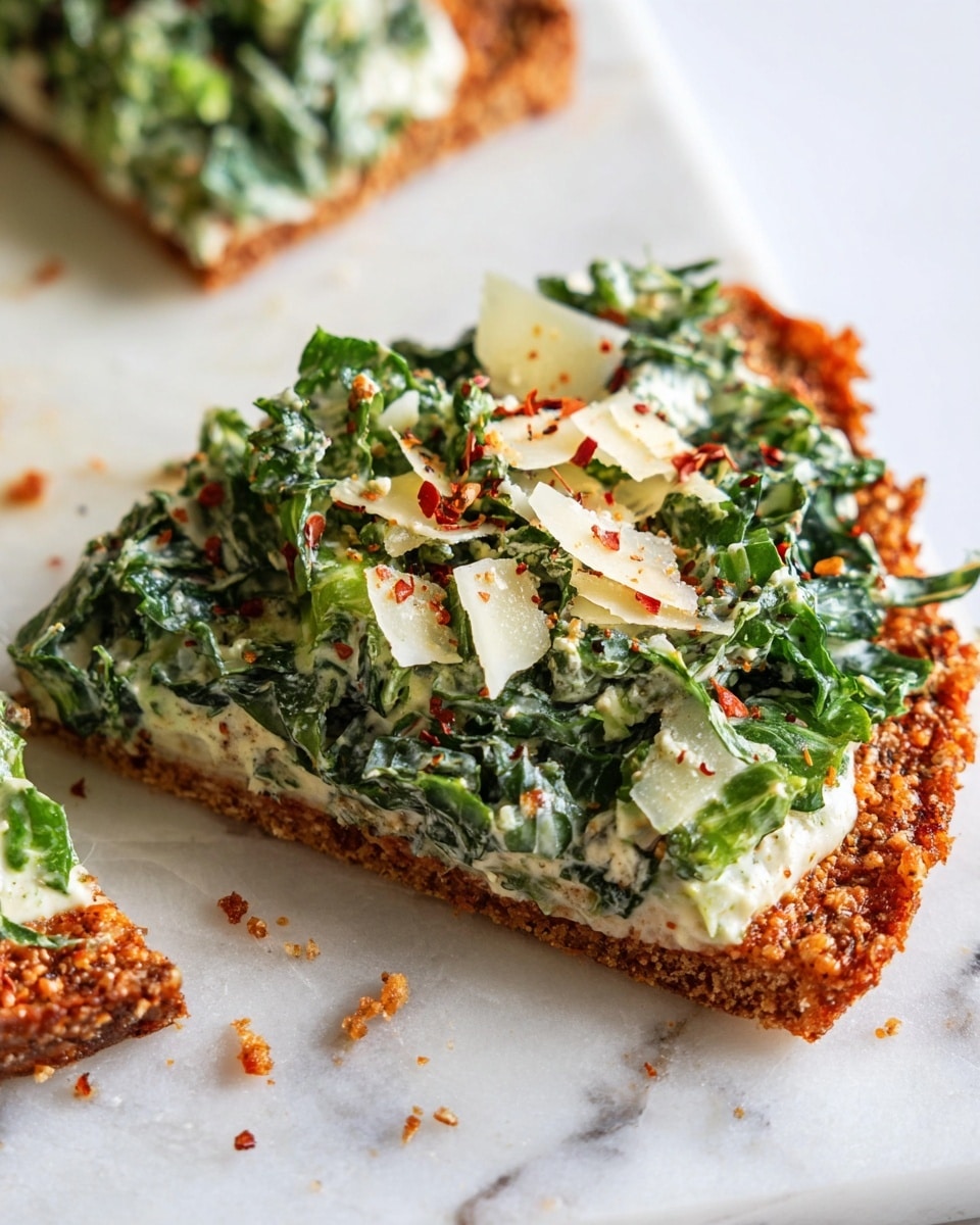 A crispy, golden-brown slice of flatbread stands at the base with rough edges and a crunchy texture. On top, there is a thick layer of creamy dressing mixed with fresh green lettuce leaves that look crisp and slightly shiny, mixed with shredded pale green vegetable pieces. Small shreds of white cheese and tiny red chili flakes are sprinkled over the top, adding a touch of color and texture. The slice is placed on a white marbled surface, and small crumbs lay around it. Photo taken with an iphone --ar 4:5 --v 7