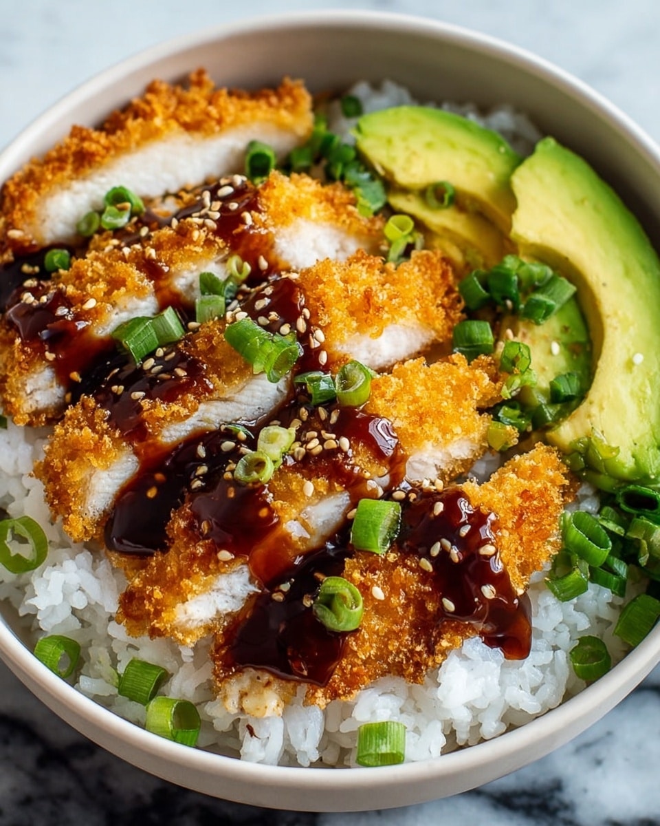 A white bowl filled with a base layer of white rice that has a soft and slightly sticky texture. On top of the rice, there is a layer of crispy golden-brown breaded chicken slices that show the juicy white inside, drizzled with a thick, glossy dark brown sauce. Around the chicken, there are small bright green chopped scallions sprinkled along with toasted sesame seeds. At the back edge inside the bowl, there are slices of fresh, light green avocado and more chopped scallions. The bowl is placed on a white marbled surface. photo taken with an iphone --ar 4:5 --v 7