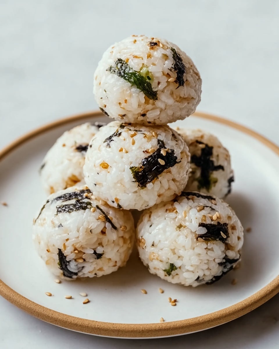 The image shows three golden-brown baked pockets on a white plate, each with a crispy and bubbly cheese layer on top lightly browned with small black pepper flakes scattered across. The pockets have a slightly crunchy, toasted dough layer underneath the cheese with some reddish tomato sauce peeking out from the edges. The background surface is a white marbled texture, making the warm colors of the pockets stand out. photo taken with an iphone --ar 4:5 --v 7