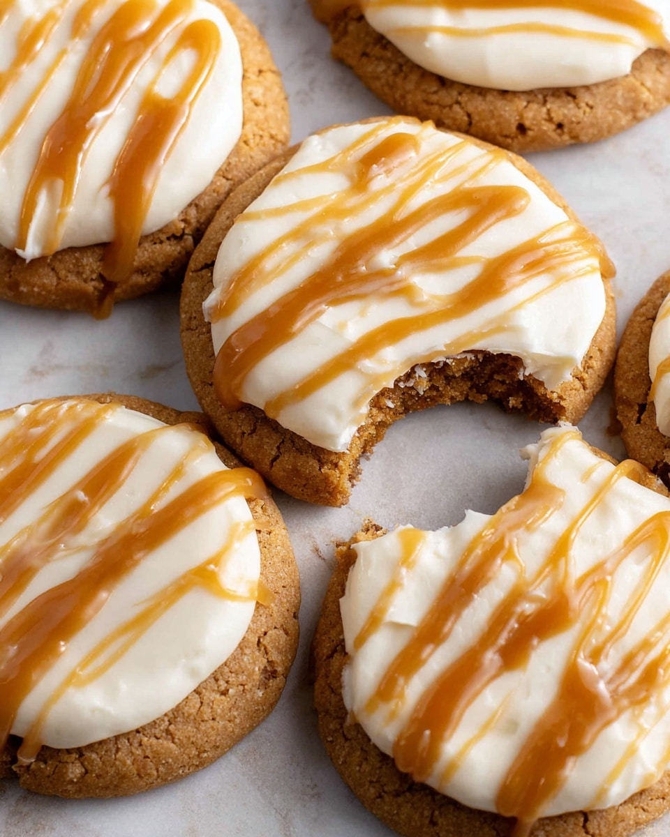 The image shows five round cookies with one cookie featuring a bite taken out of it, displaying a thick, crumbly light brown base layer. Each cookie is topped with a smooth, creamy white frosting layer that is evenly spread, creating soft peaks and swirls. Light caramel-colored sauce is drizzled in thin, parallel lines across the frosting, adding a shiny, slightly sticky texture. The cookies sit close together on a white marbled surface, with a soft focus that highlights the texture of the cookie crumbs and the creamy frosting. photo taken with an iphone --ar 4:5 --v 7