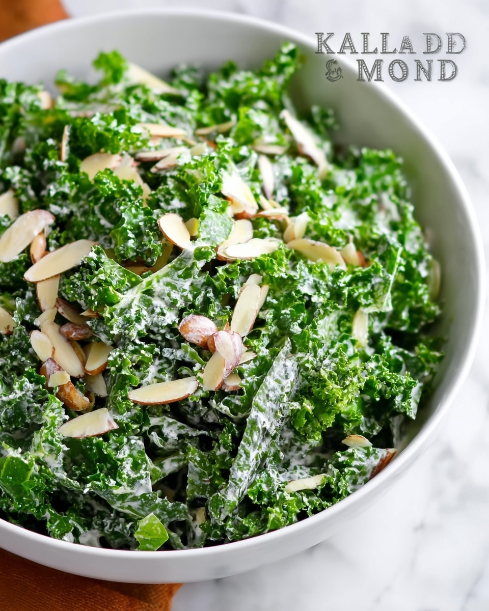 A close-up view of a fresh kale and almond salad is shown in a large white bowl. The salad has dark green, curly kale leaves as the base layer, with a creamy, white dressing lightly spread over the kale. Scattered on top are thin, pale tan almond slivers adding texture and contrast. The photo is taken on a white marbled surface, with soft natural light highlighting the salad’s fresh and healthy appearance. photo taken with an iphone --ar 4:5 --v 7